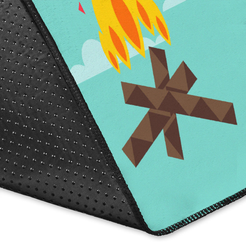 Close-up corner: teal rug with brown starburst, orange flames, and black textured edge