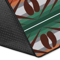 Close-up of rug corner with black edge binding and geometric bison-pattern design.