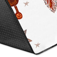 Corner view of white dreamcatcher area rug with black border and multicolor charms