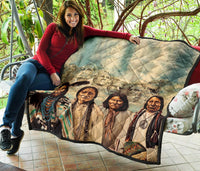 Quilt draped with Native American faces, diamond quilt pattern, multicolor accents and dark border