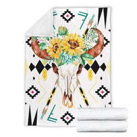 Printed bison skull floral blanket with rolled white throw pieces, geometric black accents