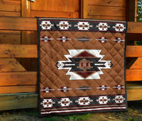 Brown quilt displayed against wooden wall with geometric border and central star emblem