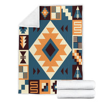 Navy arrow pattern blanket with cream starburst center and rolled white backing blankets