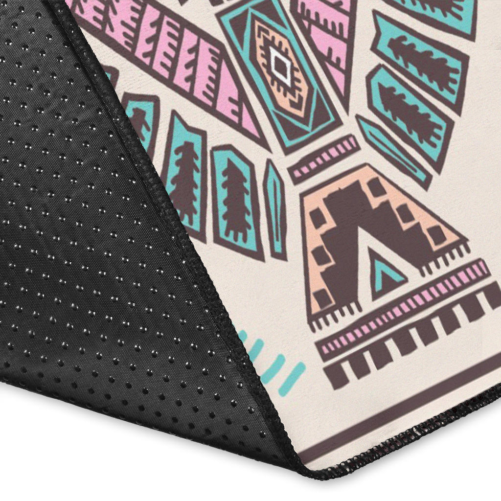 Close-up of rug edge: black border with small dot texture and tribal print