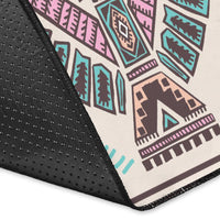 Close-up of rug edge: black border with small dot texture and tribal print