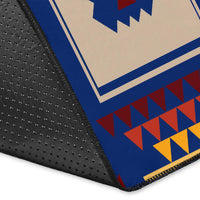Corner detail of navy tribal area rug with textured black backing and geometric print