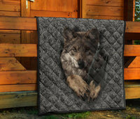 Wolf-themed quilt on porch with swirling border and quilted diamond pattern, dark tones