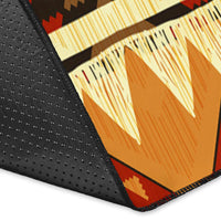 Geometric arrow area rug corner with yellow and orange panels and dark speckled black border