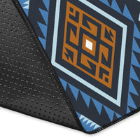 Close-up corner of blue tribal rug with stitched edge and black nonwoven backing