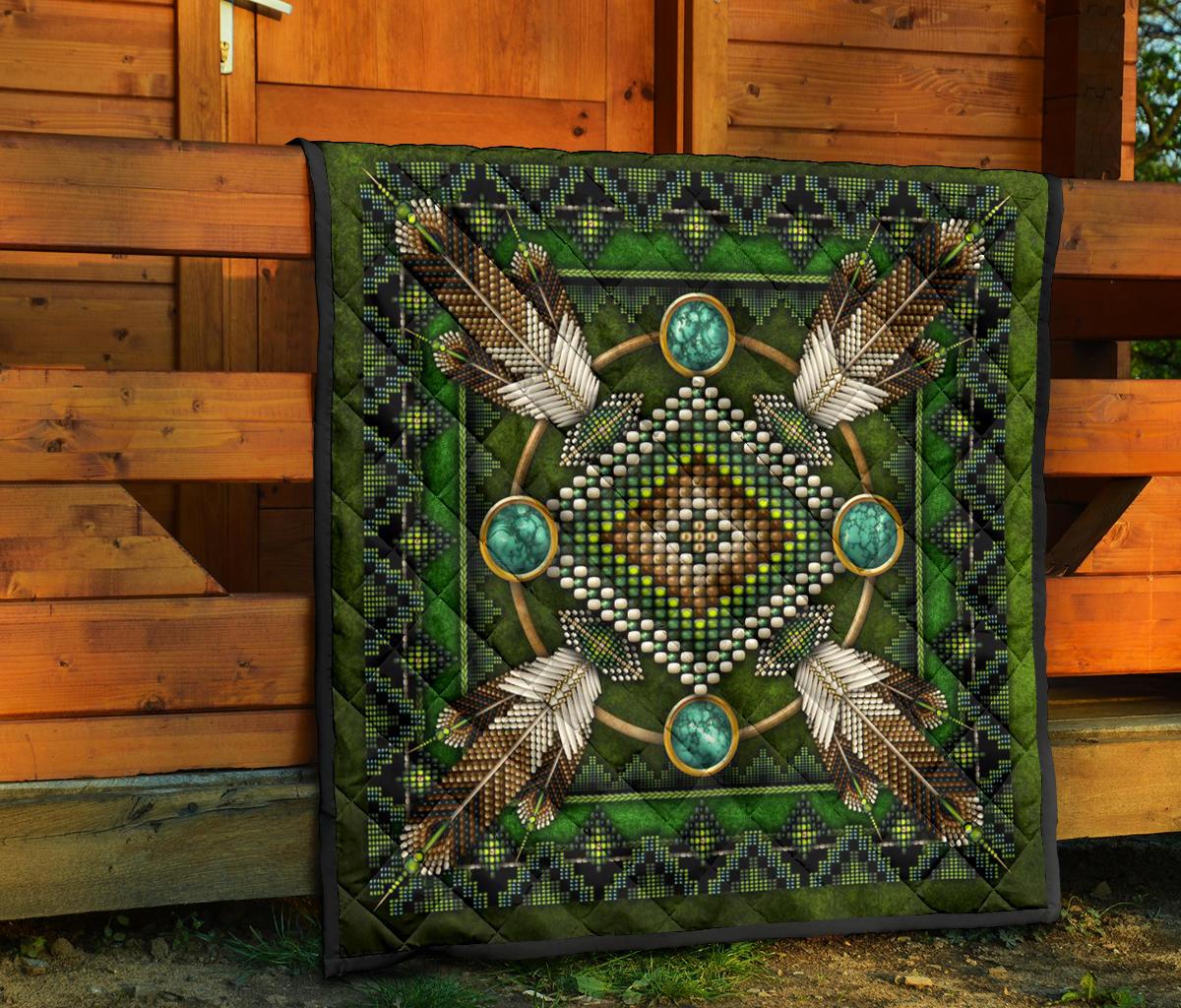 Green Native American mandala quilt on porch steps, intricate bead dots and feather designs.