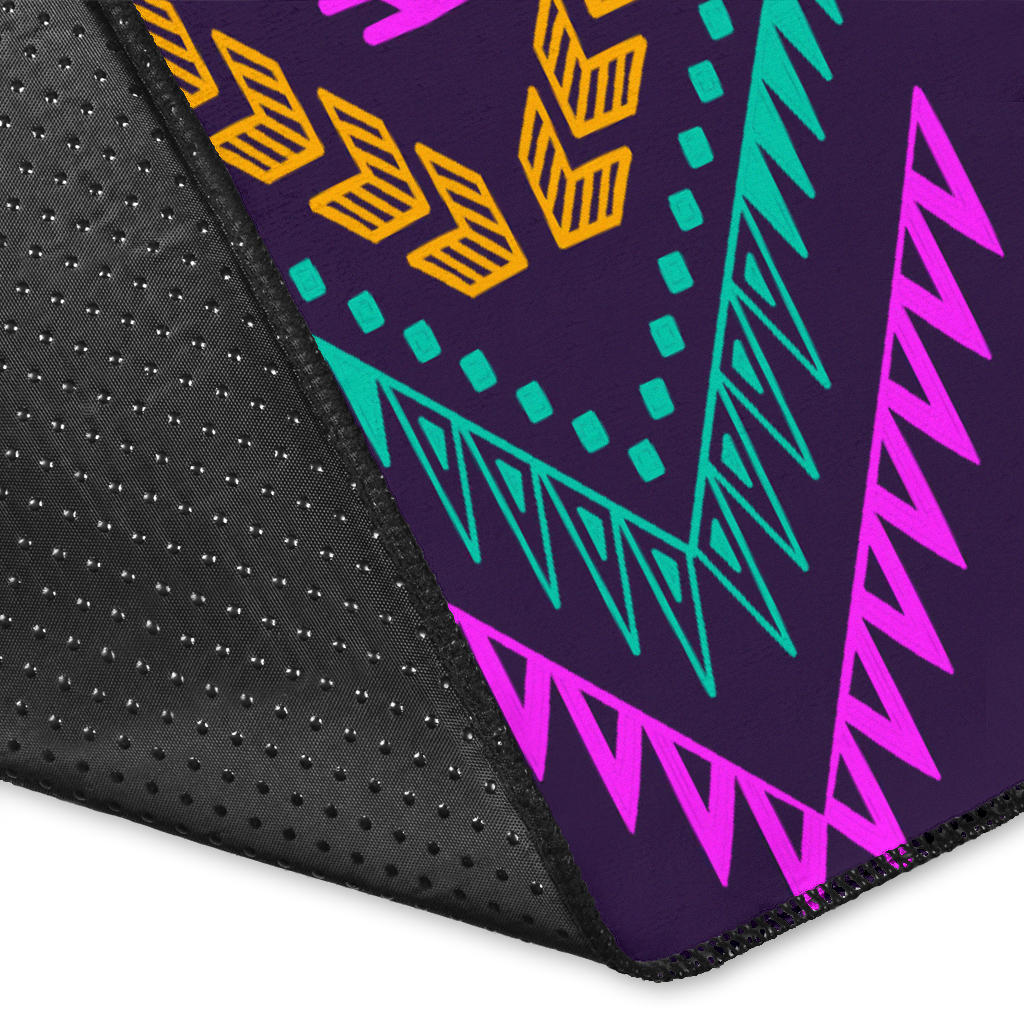 Close-up of dark purple tribal rug edge with multicolored patterns and woven texture