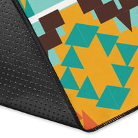 Corner view of colorful rug with black textured backing and teal-orange geometric pattern