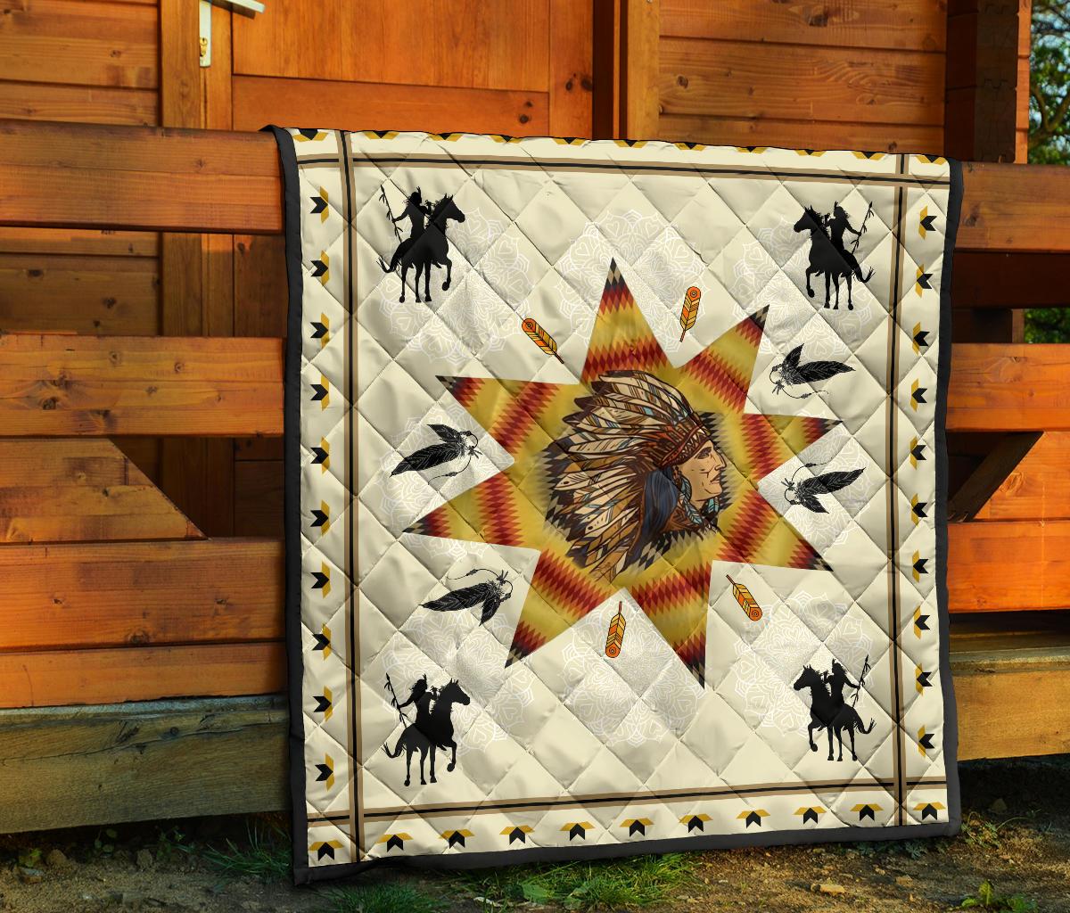 Chief and warriors quilt on porch wall; white fabric with multicolor starburst and bird silhouettes