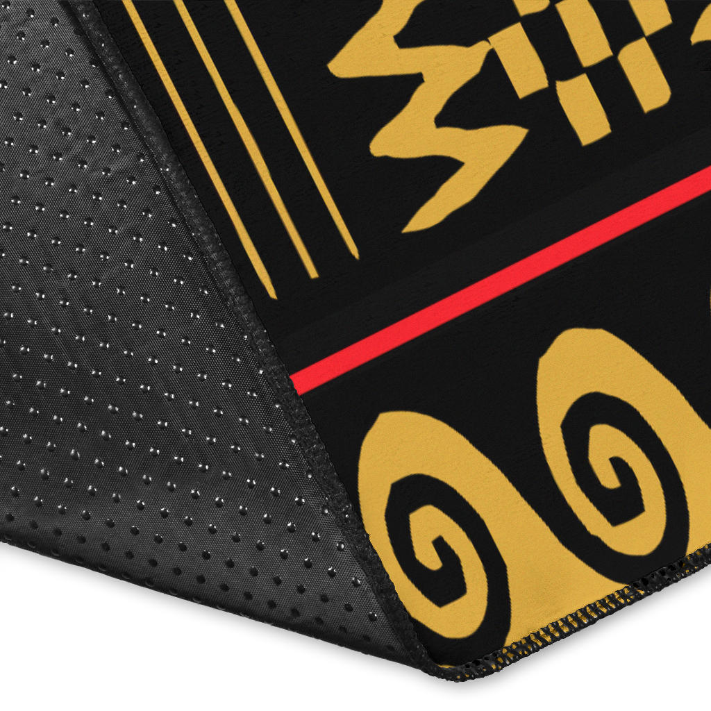 Close-up corner of black-and-yellow border with red-and-black rug edge stitching
