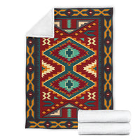 Native American blanket with matching white backing and rolled throw blankets