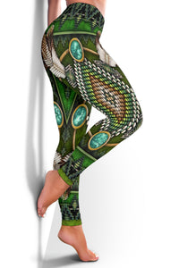 Green leggings side view with turquoise oval medallions, dense bead pattern, and feather accents