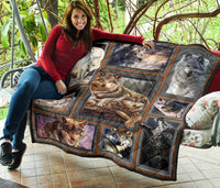 Wolf quilt laid on patio tiles, nine framed wolf portraits with dark orange edging