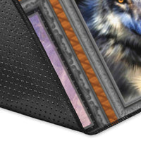 Corner close-up of multicolor wolf area rug with dark textured edging