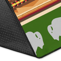 Corner close-up of green rug edge with dark border and white bison graphic