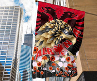 Red Albania flag with golden eagle and red lion, umbrella-like icons across bottom