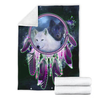 Wolf dreamcatcher blanket on a folded white backing, purple and green feather pattern