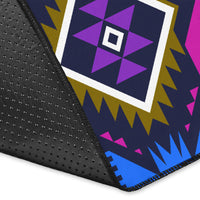 Close-up of colorful geometric area rug: purple diamond motifs on dark navy fabric