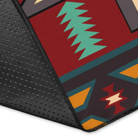 Close-up of Native American geometric rug corner with red, teal, and black patterned sections.