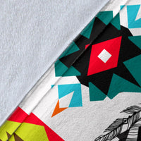 Close-up of wolf arrow blanket fabric: black, red, teal and white geometric pattern