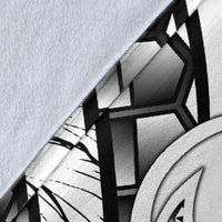 Close-up of white blanket fabric with black tribal lines and geometric motif print