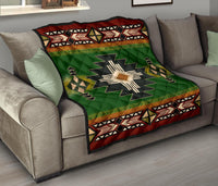 Green Southwest quilt draped on sofa, showing star medallion and red border
