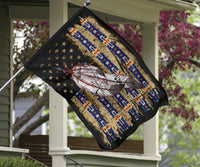 Feather flag hanging on a front porch, black background with stars and blue columns