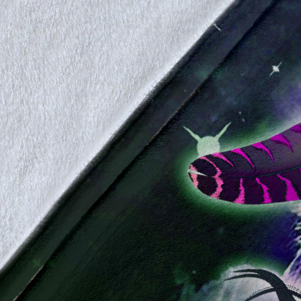Close-up of galaxy wolf blanket fabric with purple feather graphic and star details