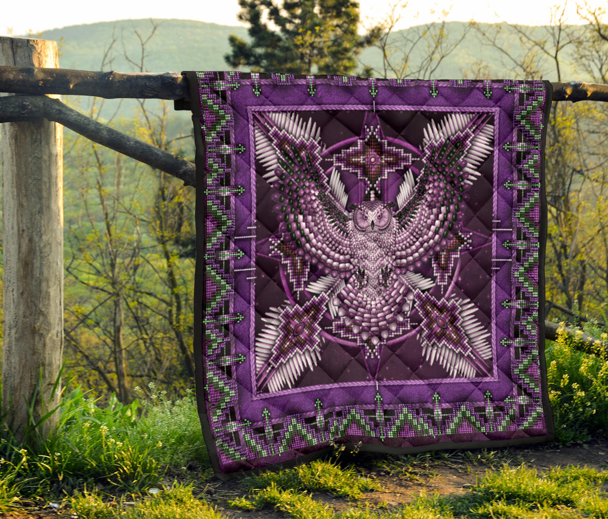 Purple mandala quilt hanging on fence post, featuring symmetrical center design and green border