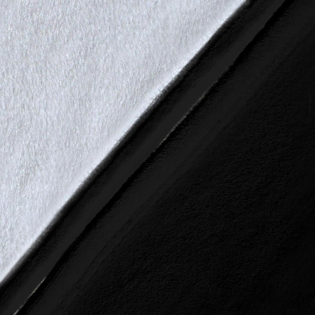 Black and white fleece throw fabric close-up with smooth, textured surface