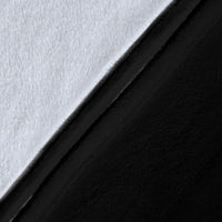 Black and white fleece throw fabric close-up with smooth, textured surface