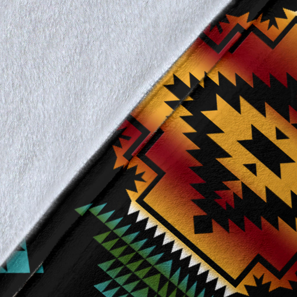 Close-up of black fabric with multicolor geometric pattern in teal, red, yellow