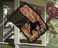 Diamond-shaped view of hanging flag decor with horse silhouette and red native motifs