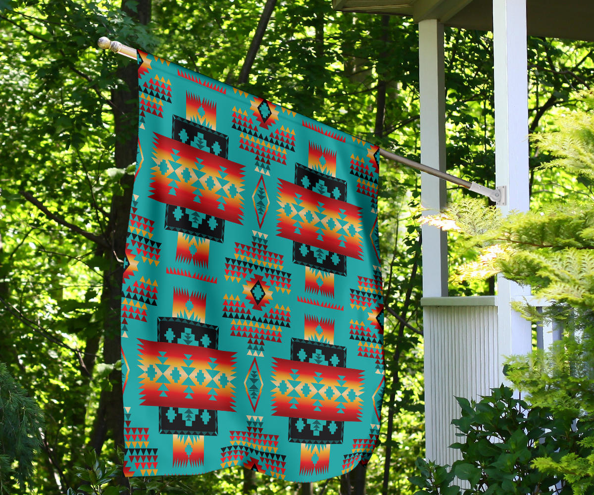 Multicolor geometric pattern flag hanging from porch, teal with orange and red panel motifs