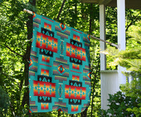 Multicolor geometric pattern flag hanging from porch, teal with orange and red panel motifs
