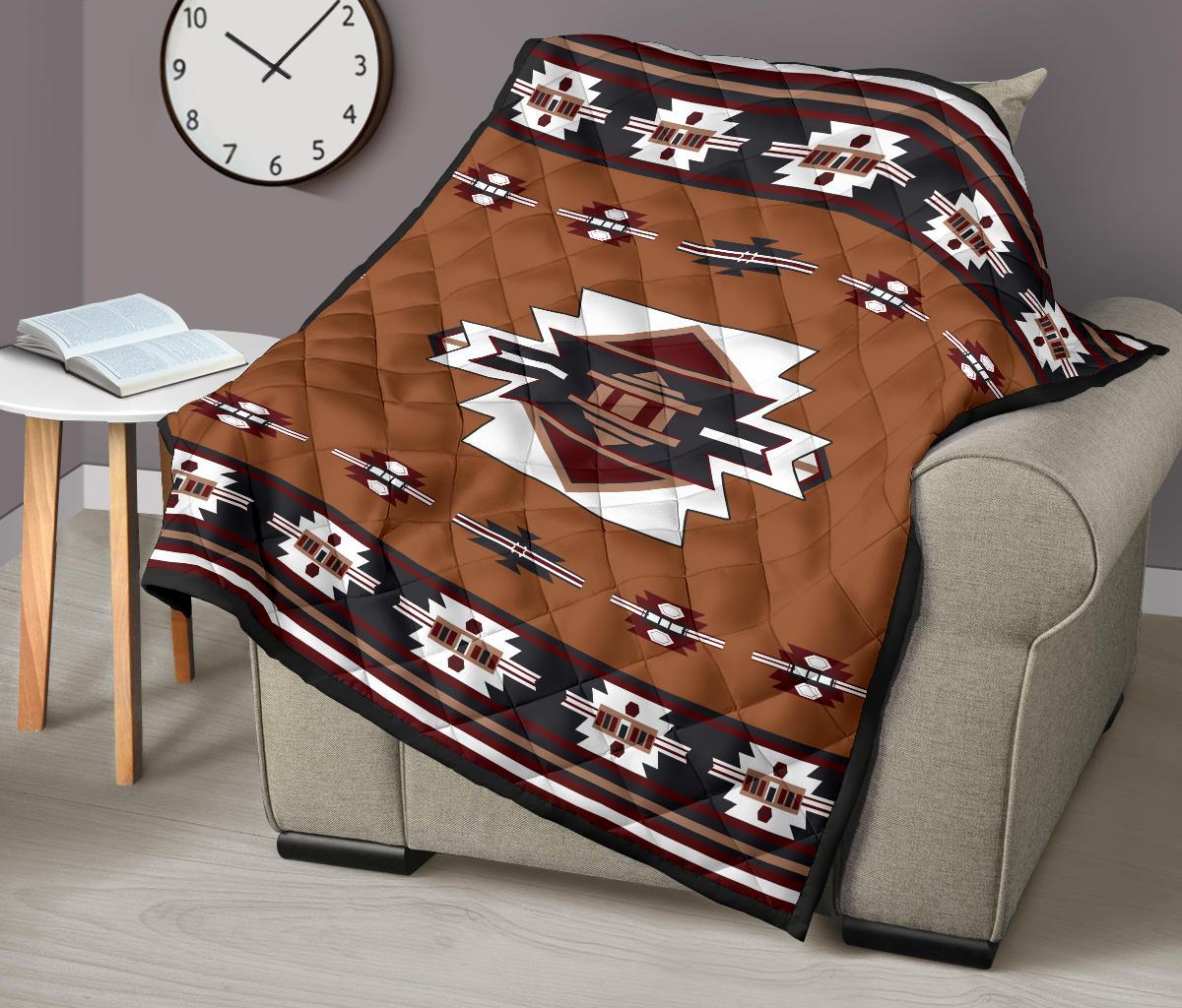 Brown quilt on beige armchair with central star emblem, stripe motifs, and patterned border