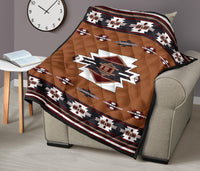 Brown quilt on beige armchair with central star emblem, stripe motifs, and patterned border