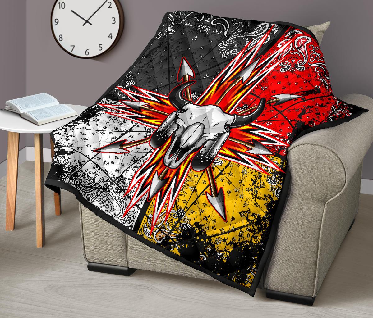 Bison skull quilt with multicolor arrow rays, shown spread over a beige chair