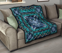 Teal and navy quilt over a sofa with blue mandala center and patterned corner panels