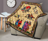 Multicolor Native-themed quilt on an armchair, featuring rider, dancers, and bird motifs