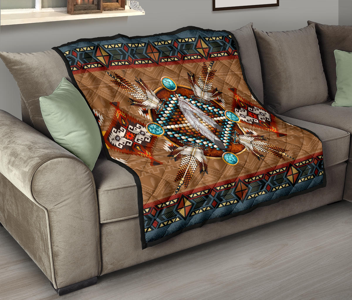 Brown quilt blanket with turquoise bead circles and central white feather motif, dark patterned edge