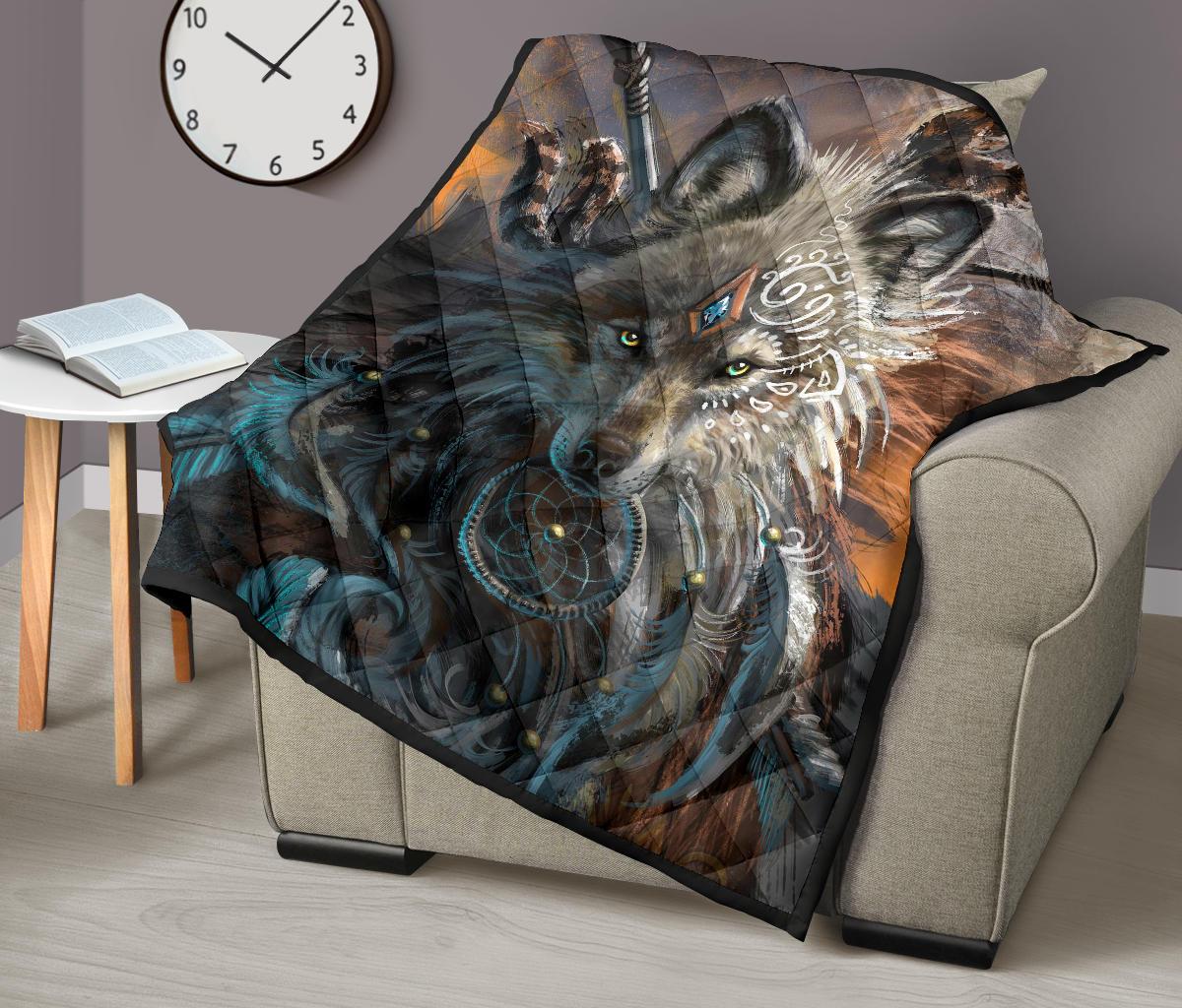 Wolf quilt folded over an armchair, featuring gray and brown wolf head with turquoise swirls
