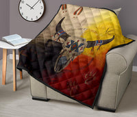 Bison quilt on beige sofa with multicolor buffalo head and red-yellow-black color blocks.
