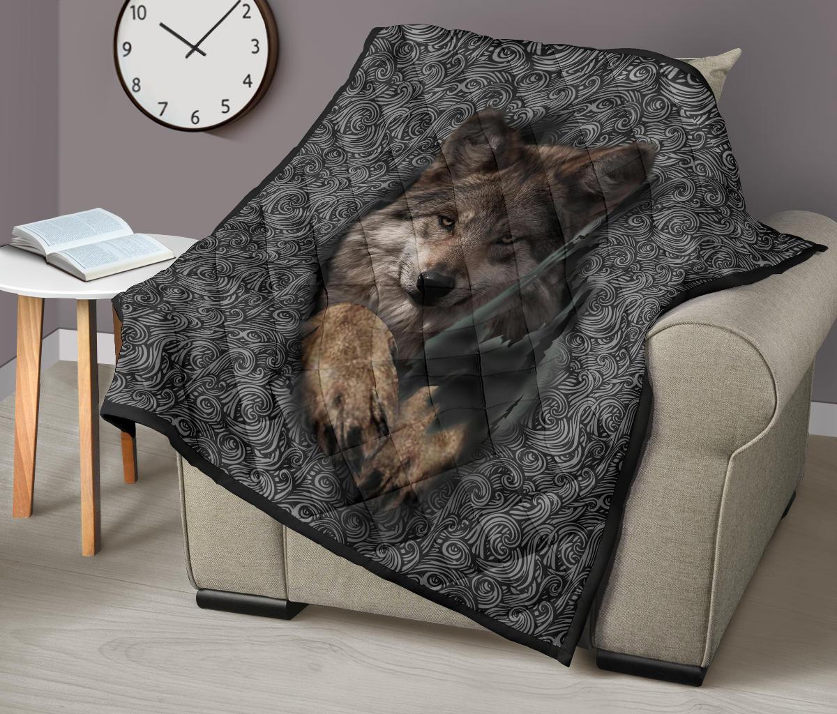 Wolf portrait quilt folded over beige sofa arm with swirling black-gray border