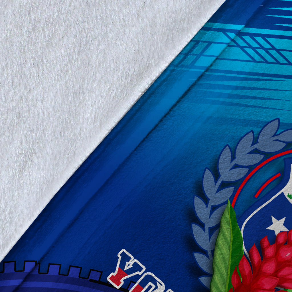 Close-up of blue blanket fabric with crest laurel print and white patterned edge