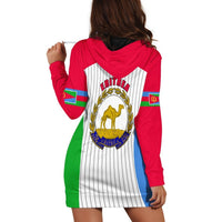 Back view red hooded dress with white striped panels and large Eritrea crest in gold
